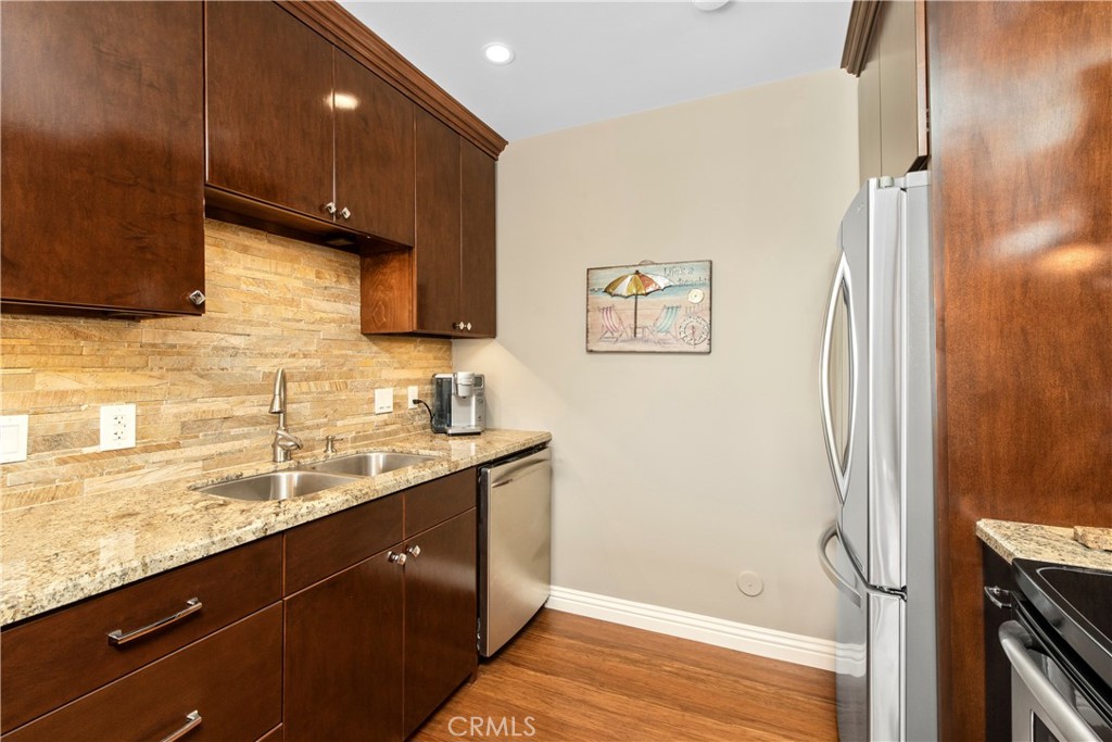 33623 Avenida Capri, Unit 60 Dana Point, CA 92629 - Photo 8 of 38 a bathroom with a granite countertop sink a mirror and shower