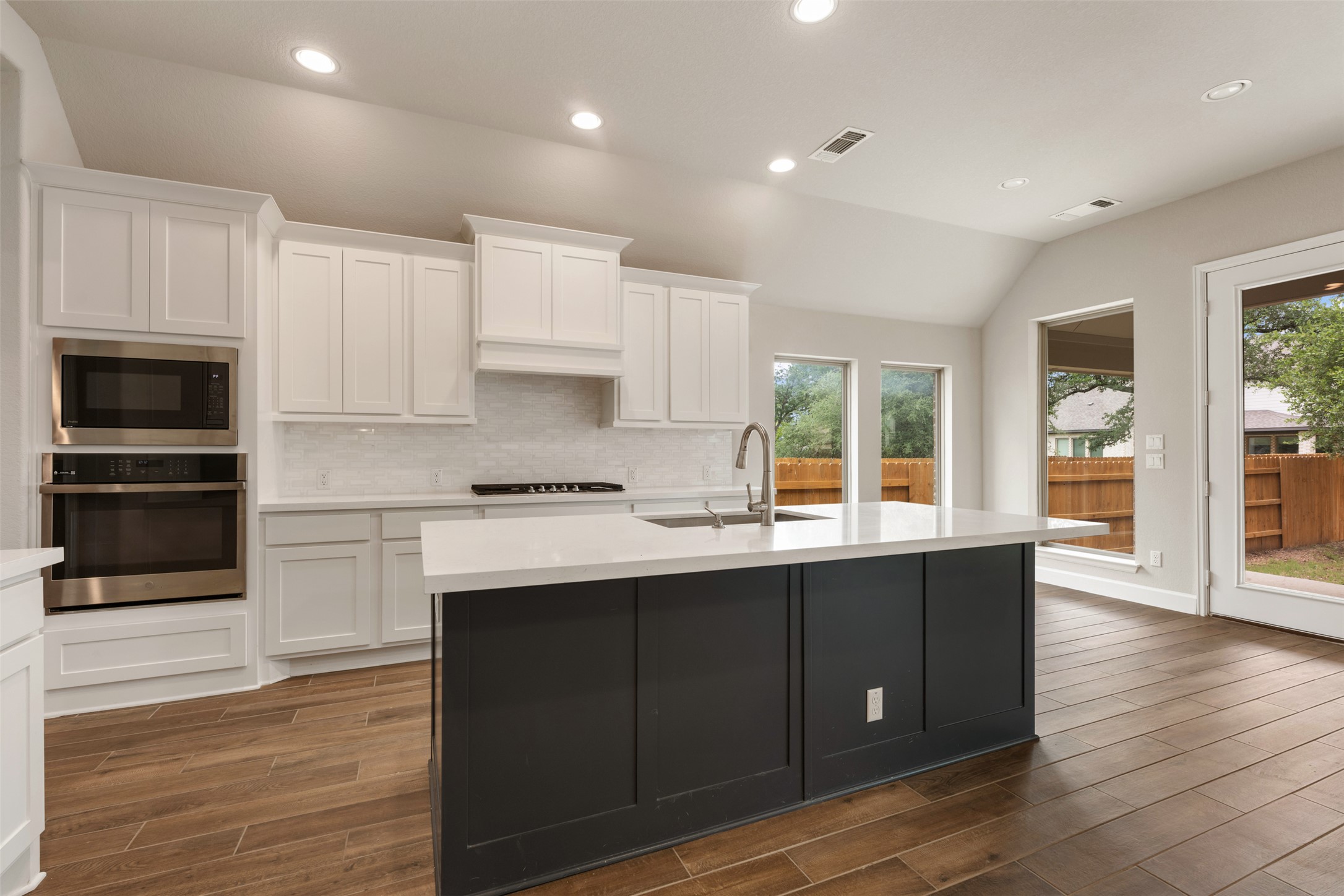 104 Anejo Bluff Georgetown, TX 78628 - Photo 6 of 40 a kitchen with a sink cabinets and wooden floor