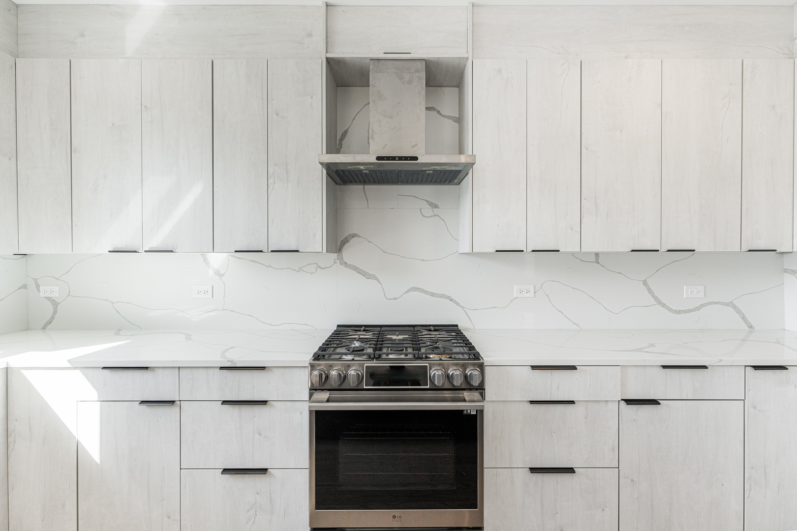 8121 W Forest Chicago, IL 60634 - Photo 11 of 44 a kitchen with granite countertop white cabinets and white stove