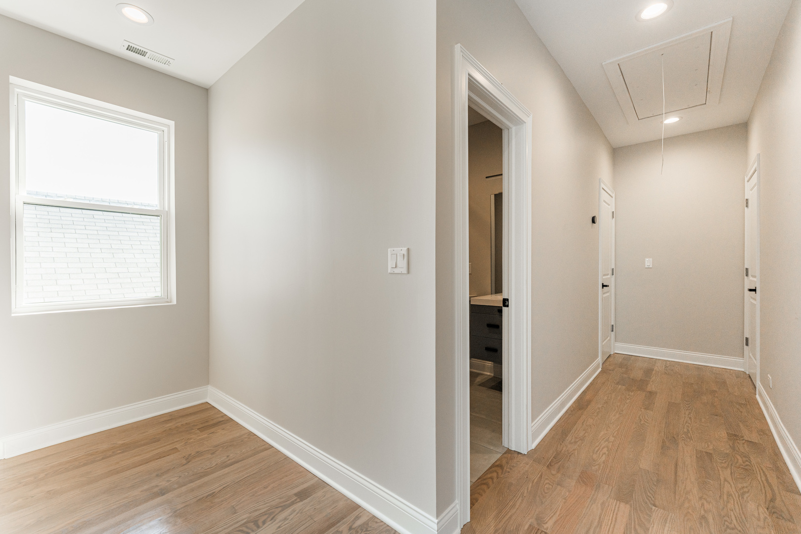 8121 W Forest Chicago, IL 60634 - Photo 16 of 44 a view of a hallway with wooden floor and a bathroom