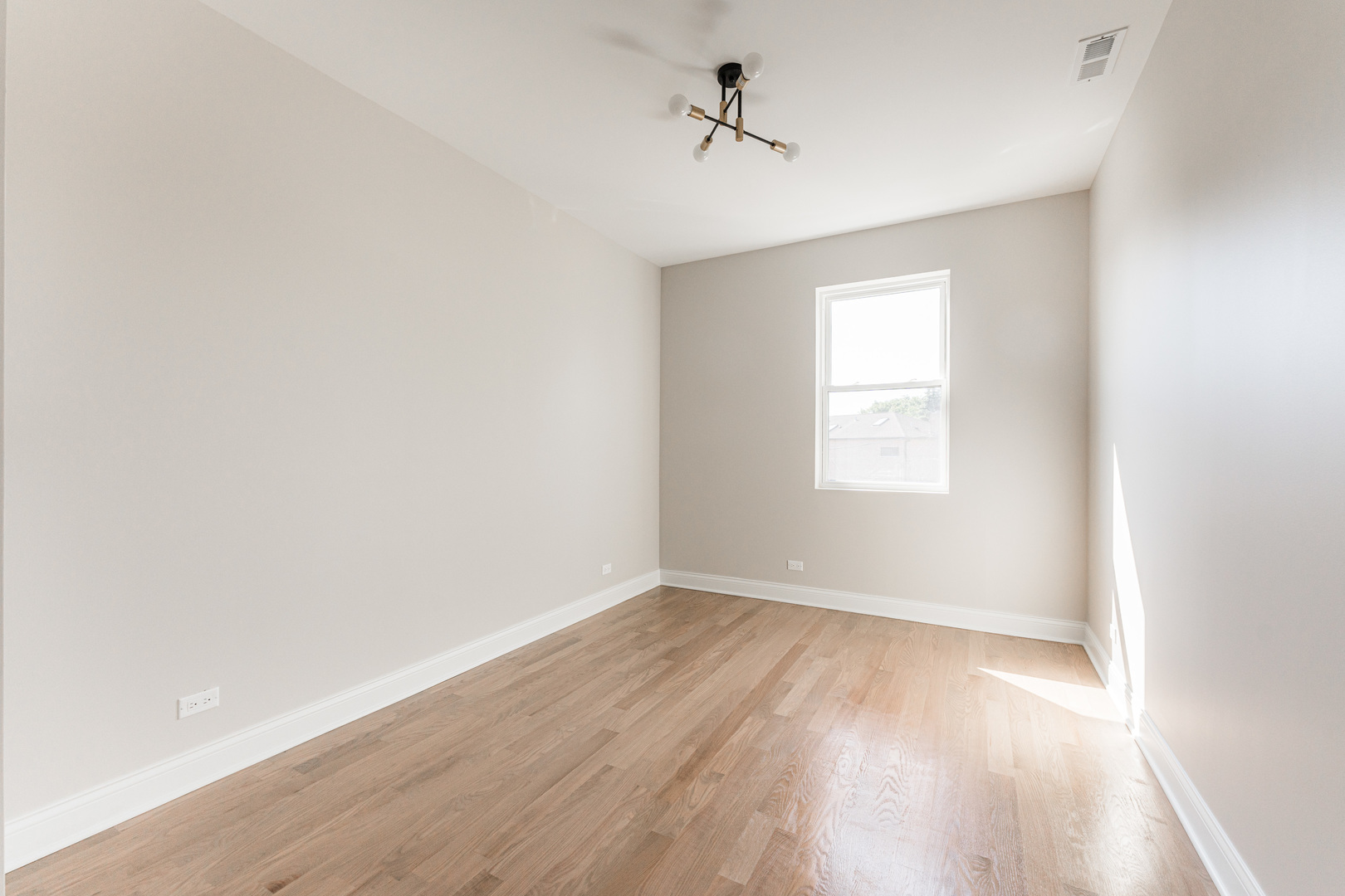 8121 W Forest Chicago, IL 60634 - Photo 23 of 44 an empty room with wooden floor and windows