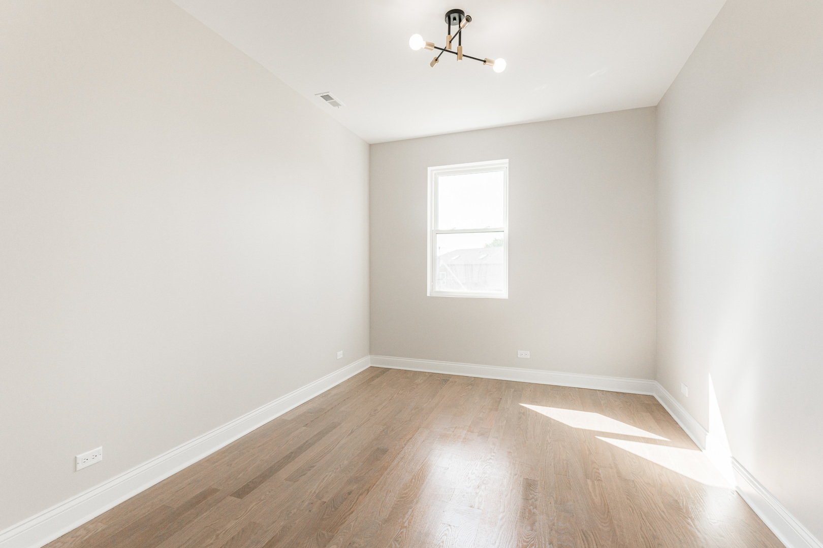 8121 W Forest Chicago, IL 60634 - Photo 25 of 44 an empty room with a window and wooden floor