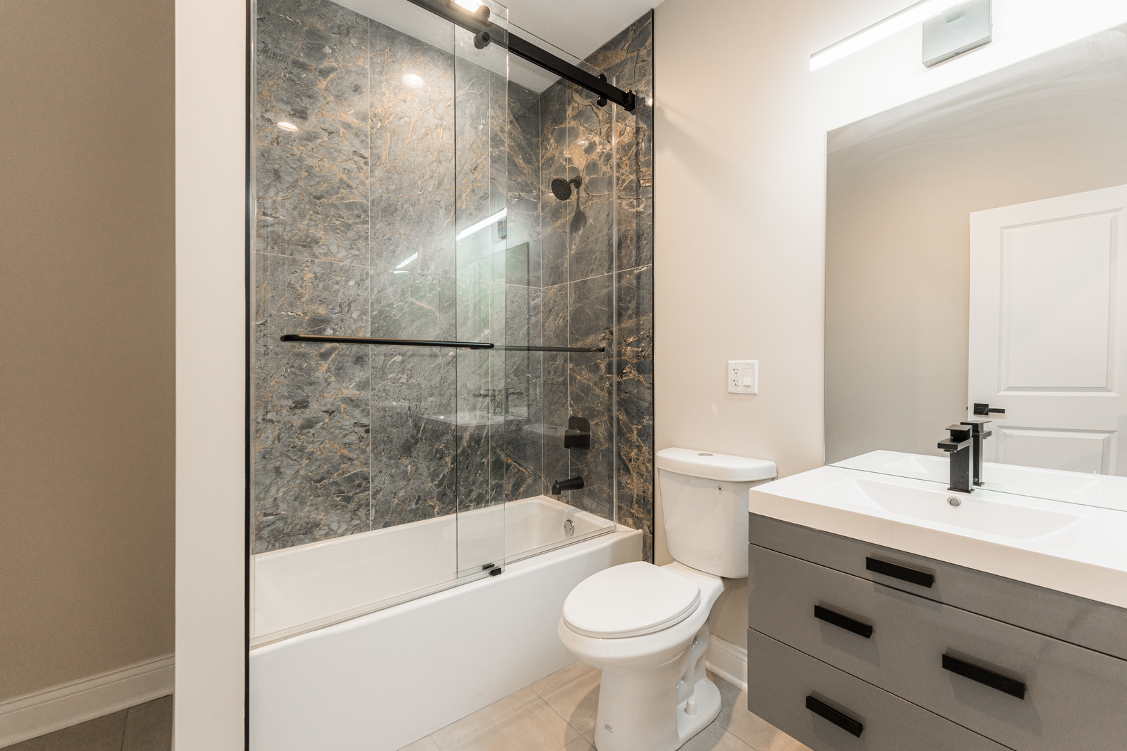 8121 W Forest Chicago, IL 60634 - Photo 27 of 44 a bathroom with a sink a toilet and shower