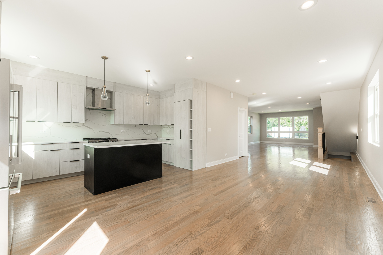 8121 W Forest Chicago, IL 60634 - Photo 8 of 44 a large kitchen with kitchen island a sink dishwasher a stove and a refrigerator with wooden floor