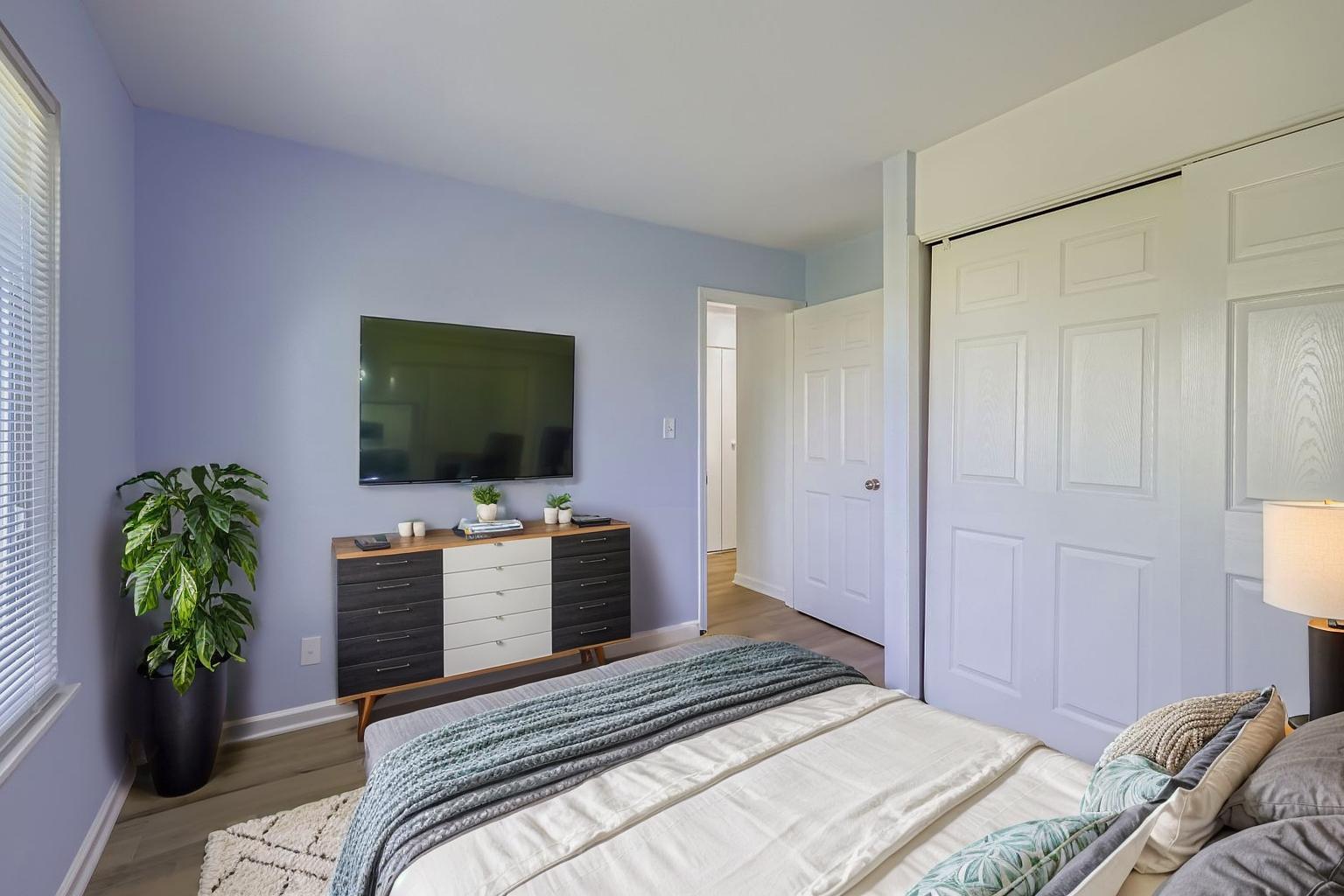 7526 Bristol Lane, Unit 2 Hanover Park, IL 60133 - Photo 17 of 21 a bedroom with a bed and a flat screen tv