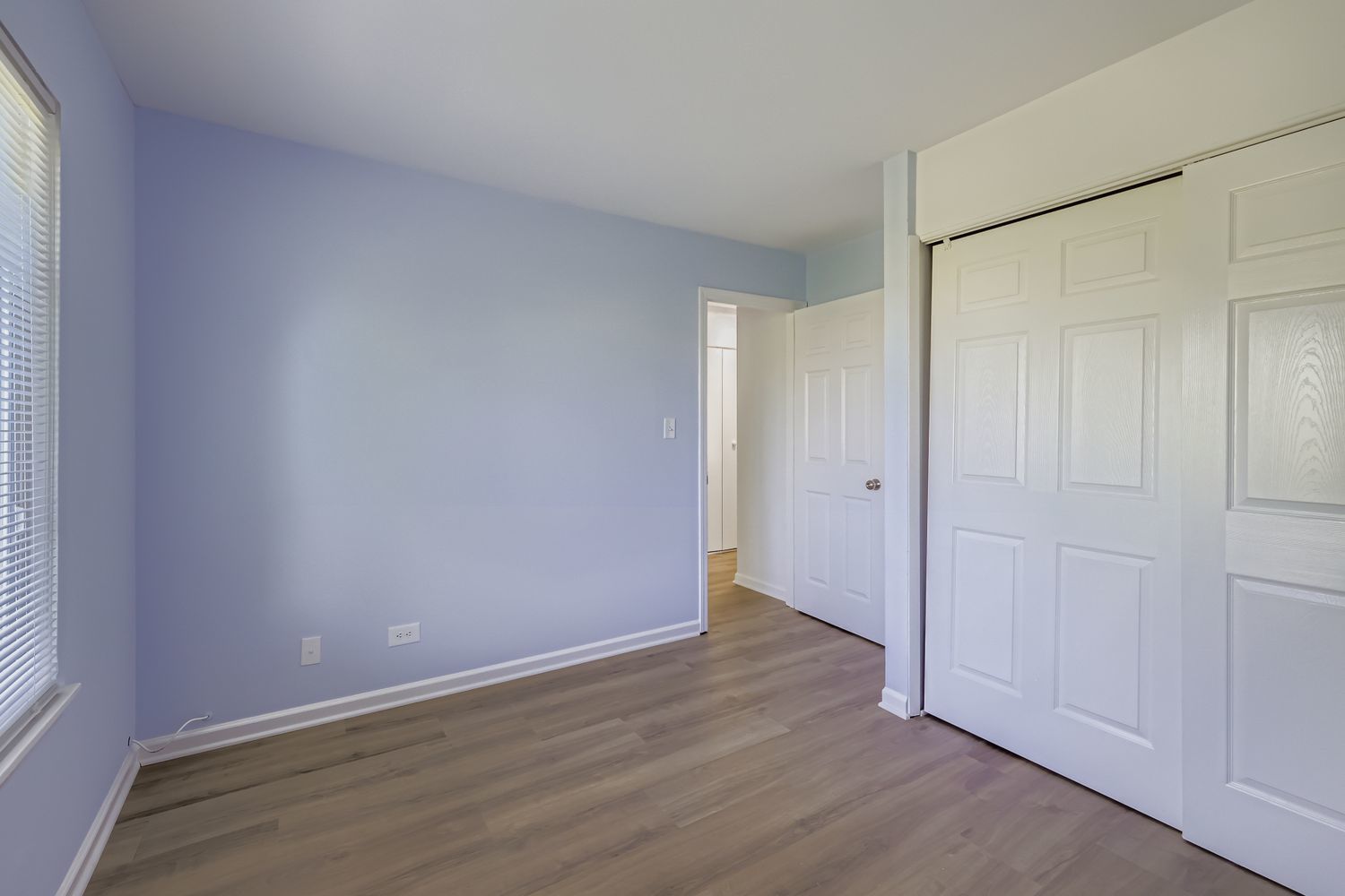 7526 Bristol Lane, Unit 2 Hanover Park, IL 60133 - Photo 18 of 21 an empty room with wooden floor and windows