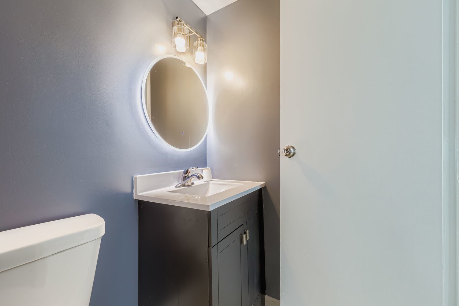7526 Bristol Lane, Unit 2 Hanover Park, IL 60133 - Photo 4 of 21 a bathroom with a toilet a sink and mirror