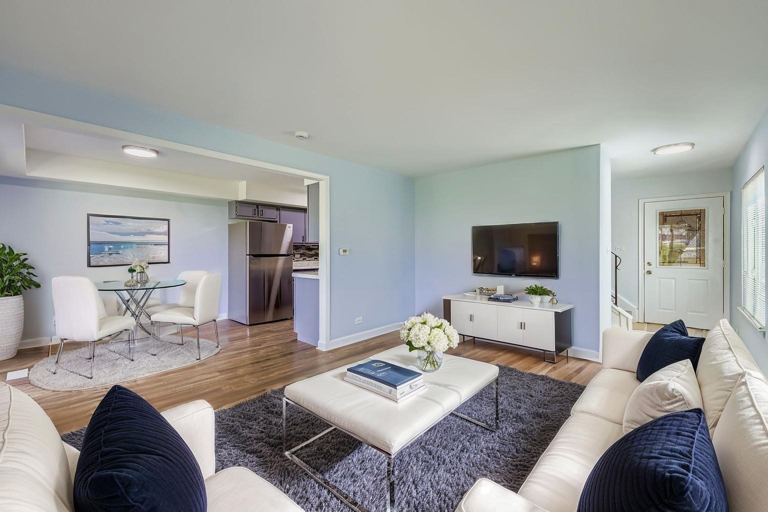 7526 Bristol Lane, Unit 2 Hanover Park, IL 60133 - Photo 5 of 21 a living room with furniture and a flat screen tv