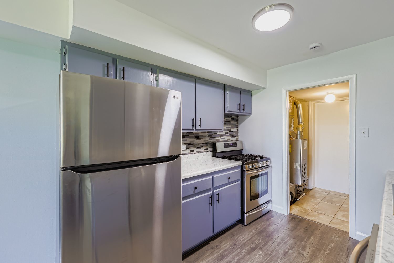 7526 Bristol Lane, Unit 2 Hanover Park, IL 60133 - Photo 9 of 21 a kitchen with a refrigerator a stove top oven a sink and dishwasher