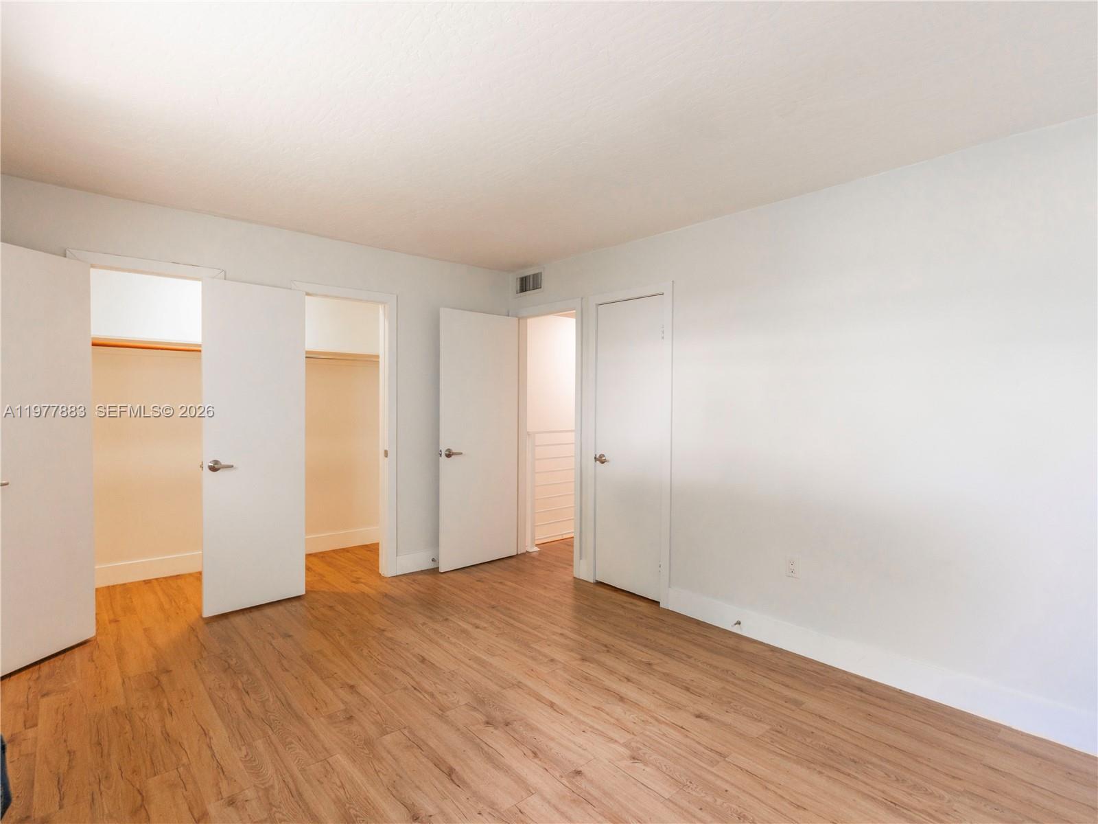 8329 Southwest 137th Avenue, Unit 8329 Miami, FL 33183 - Photo 20 of 33 a view of an empty room with wooden floor