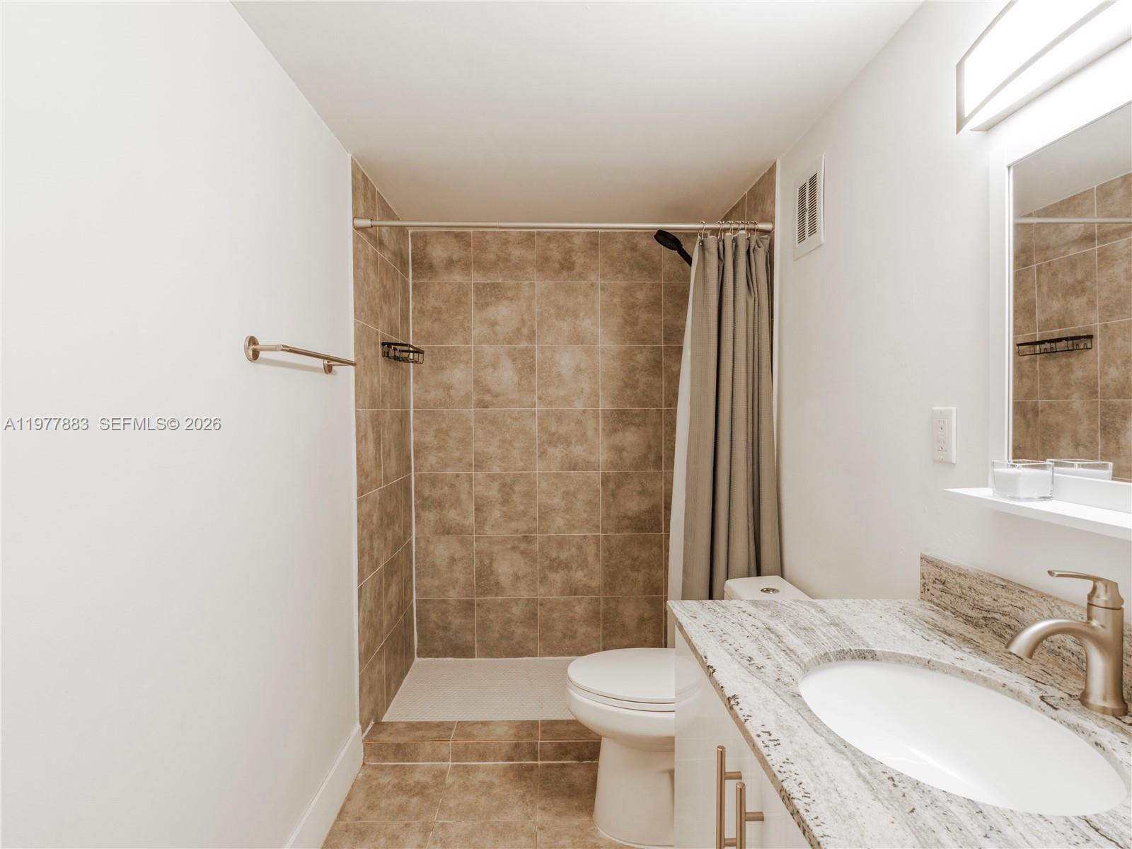 8329 Southwest 137th Avenue, Unit 8329 Miami, FL 33183 - Photo 22 of 33 a bathroom with a sink a toilet and shower