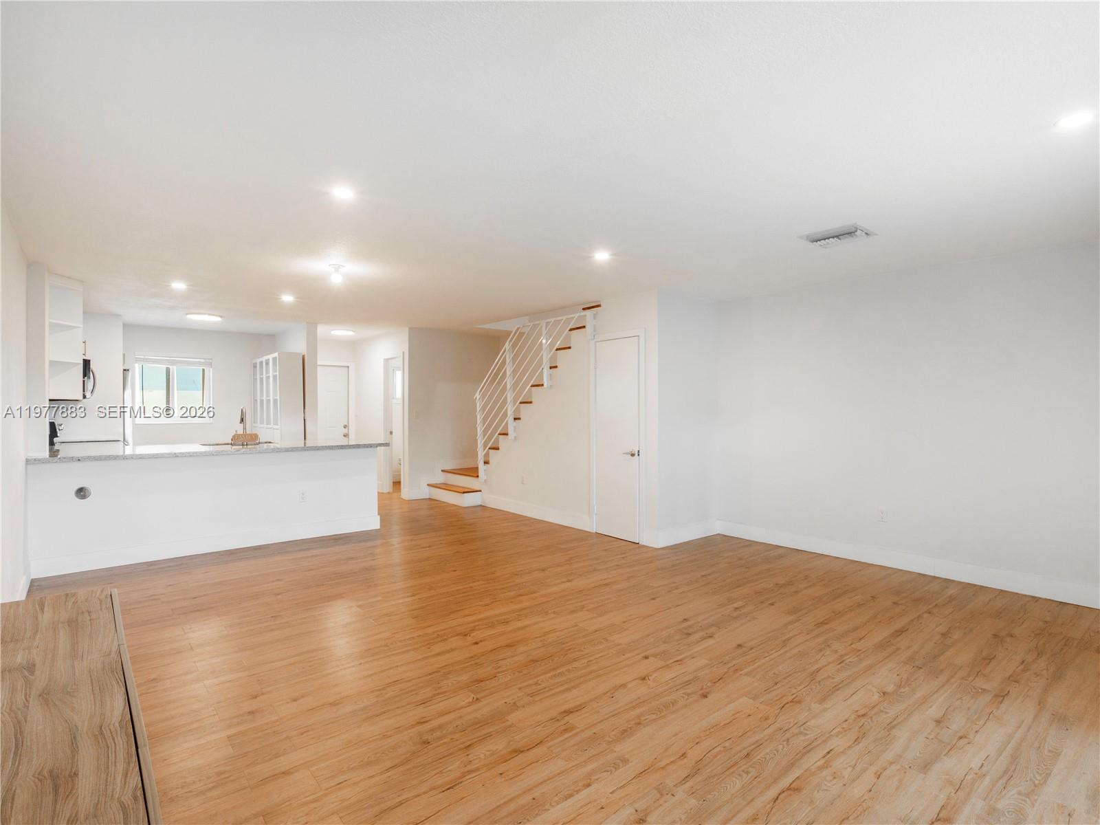 8329 Southwest 137th Avenue, Unit 8329 Miami, FL 33183 - Photo 10 of 33 a view of kitchen with kitchen island sink and wooden floor