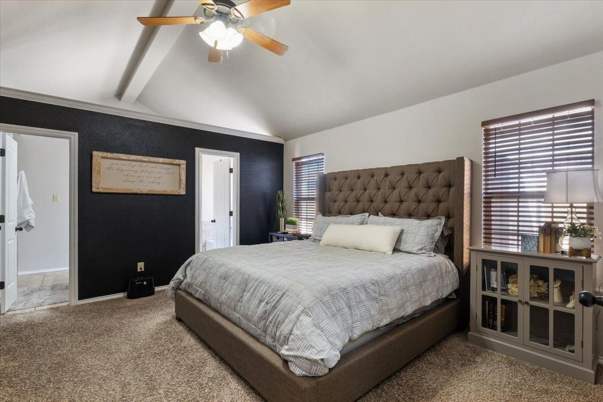 9804 Juneau Avenue Lubbock, TX 79424 - Photo 13 of 30 a bedroom with a large bed and a chandelier