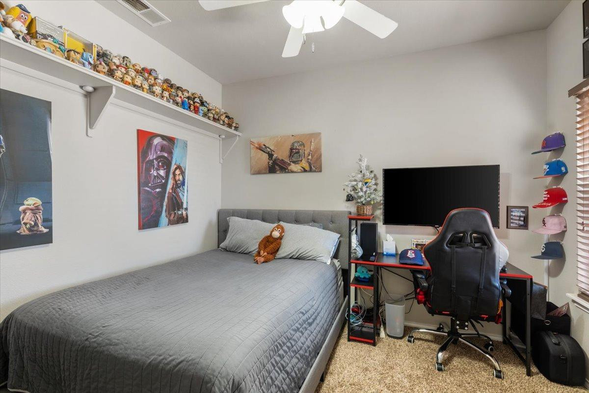 9804 Juneau Avenue Lubbock, TX 79424 - Photo 19 of 30 a bedroom with a bed and a computer on the desk