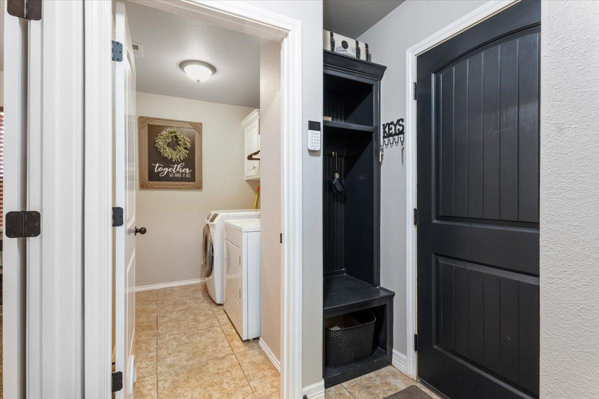 9804 Juneau Avenue Lubbock, TX 79424 - Photo 25 of 30 a view of a hallway with a refrigerator and a stove