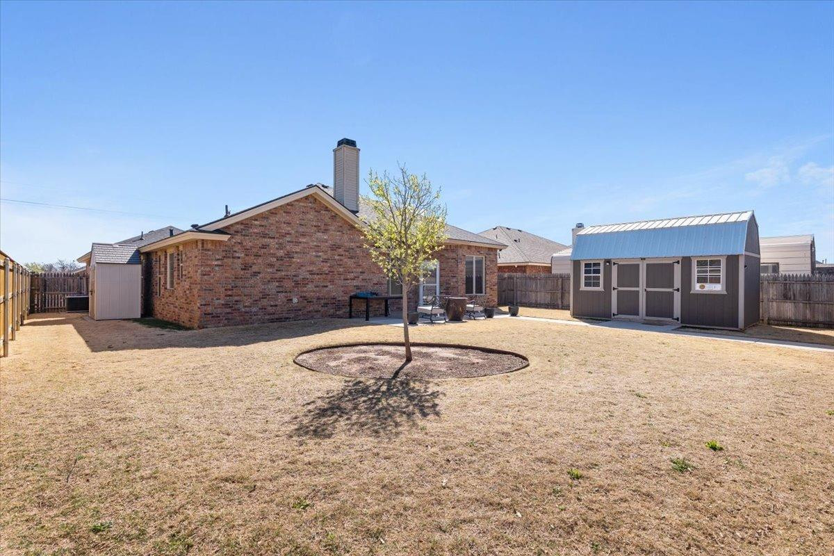 9804 Juneau Avenue Lubbock, TX 79424 - Photo 29 of 30 a swimming pool with outdoor seating and house in the background