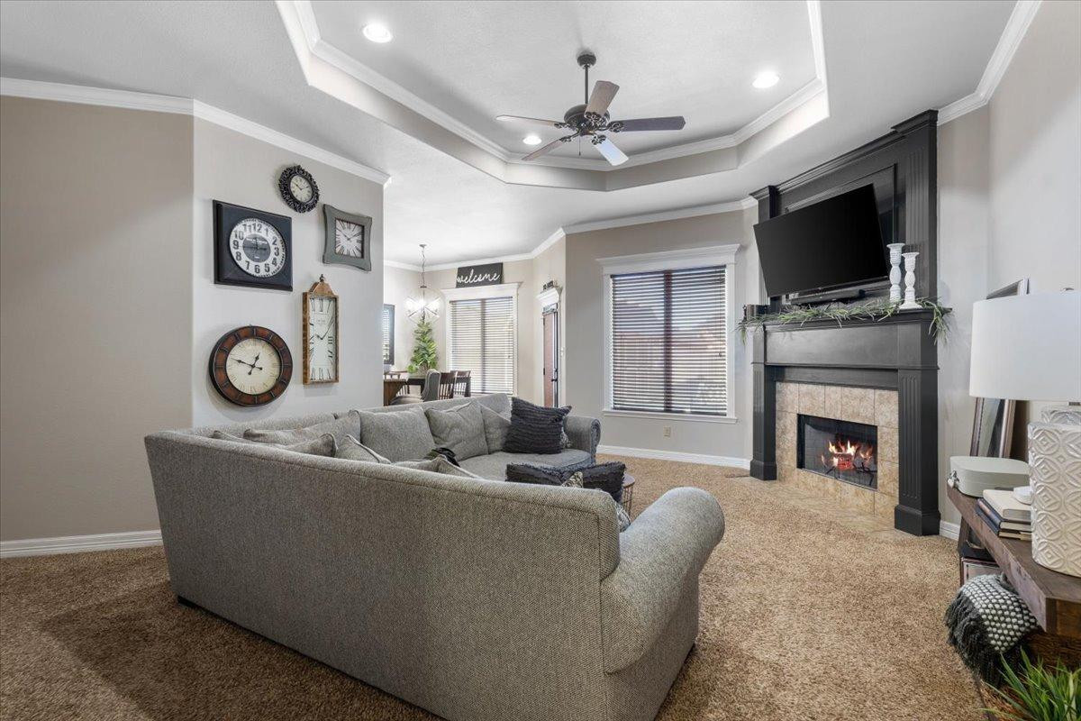 9804 Juneau Avenue Lubbock, TX 79424 - Photo 5 of 30 a living room with fireplace furniture and a flat screen tv