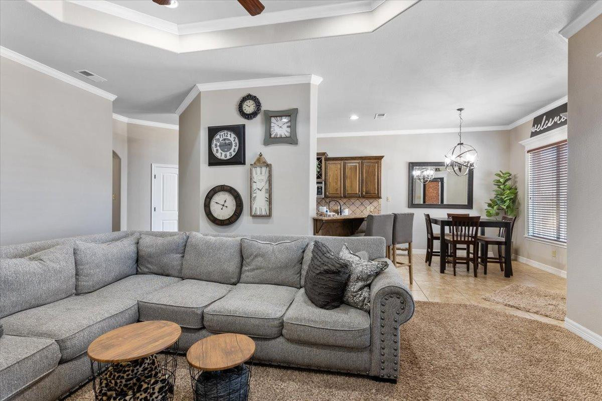 9804 Juneau Avenue Lubbock, TX 79424 - Photo 8 of 30 a living room with furniture a clock and a table