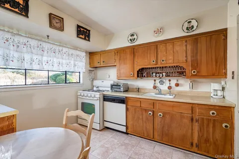 a kitchen with a sink cabinets and window