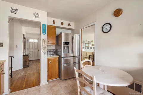 a kitchen with stainless steel appliances granite countertop a refrigerator a sink and white cabinets