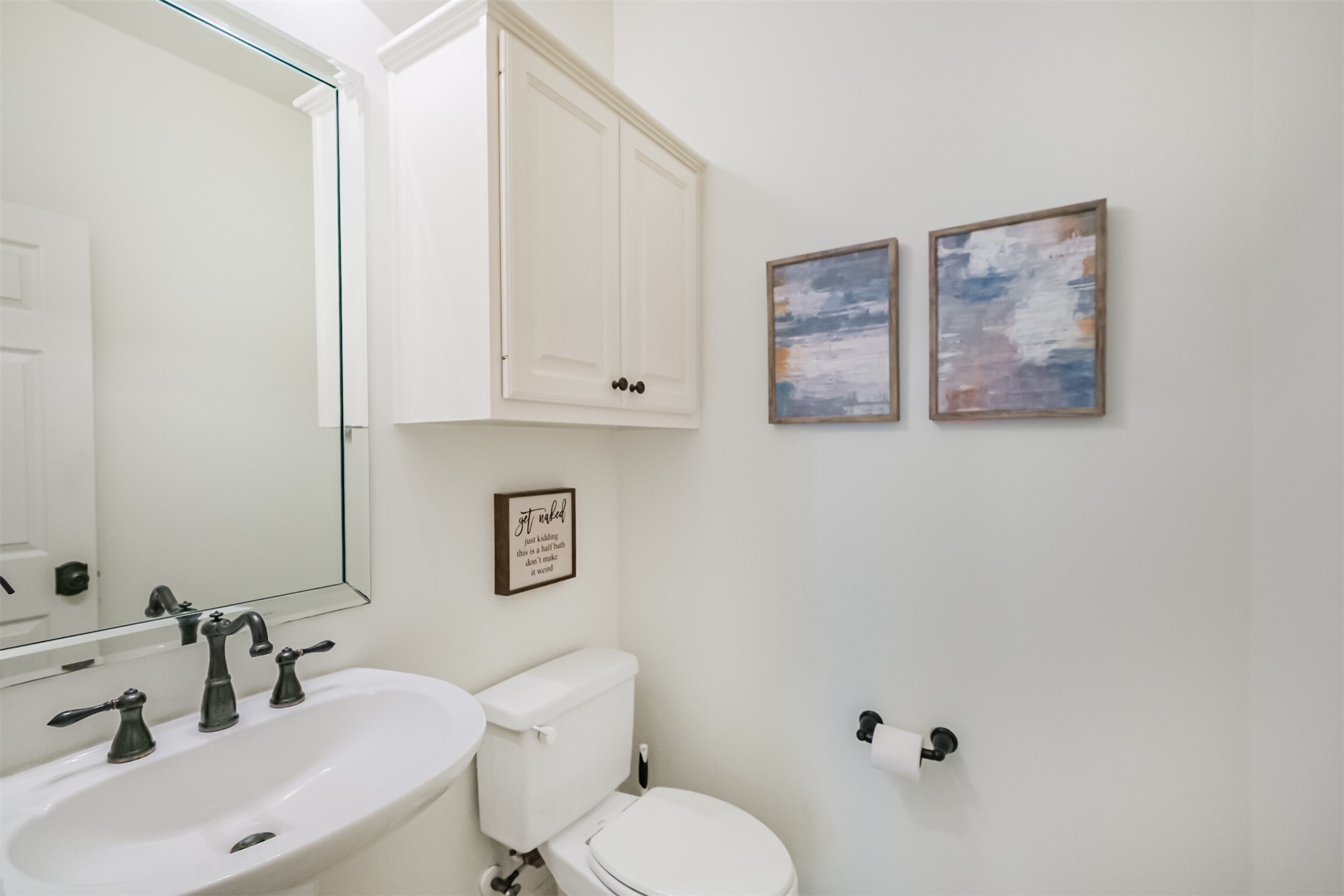 14919 Codys Run Cypress, TX 77429 - Photo 23 of 32 Downstairs powder bathroom conveniently located near the sunroom.