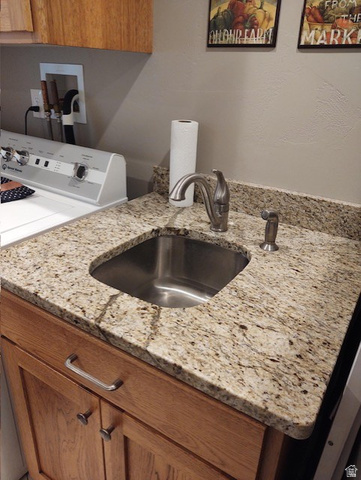 2170 Highway 357 Beaver, UT 84713 - Photo 47 of 56 Laundry area featuring a stainless steel sink, granite countertop, and wood-finish cabinetry