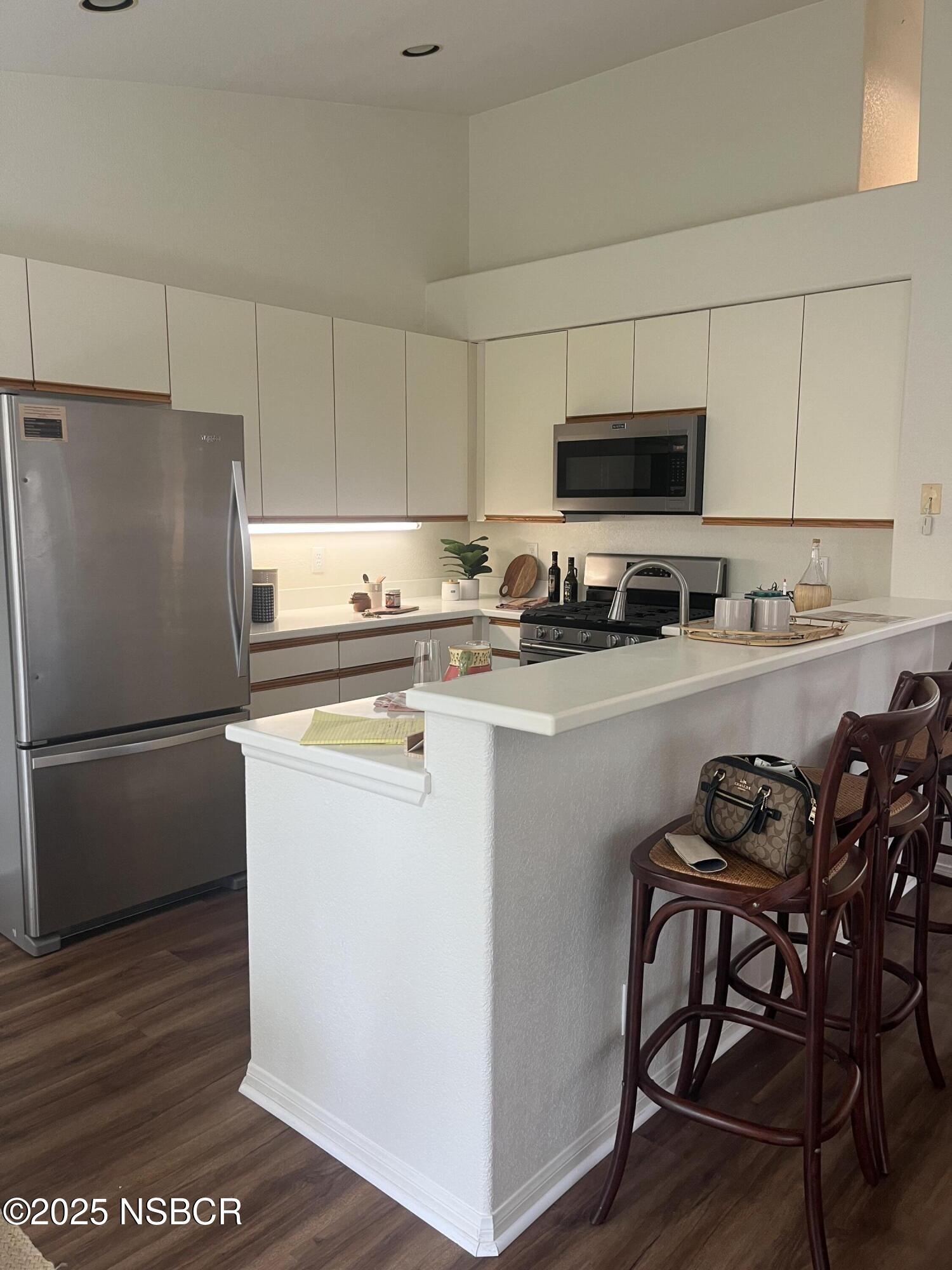 227 Valley Dairy Road Buellton, CA 93427 - Photo 7 of 10 a kitchen with stainless steel appliances a refrigerator a stove a sink and white cabinets