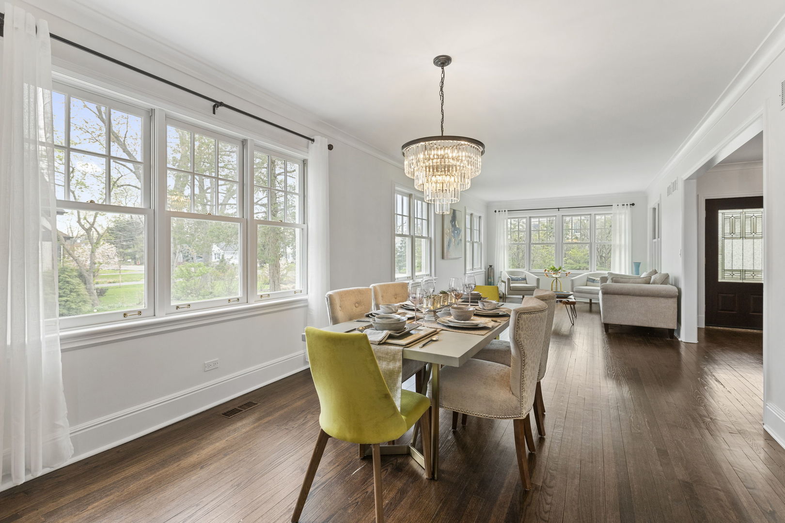 91 Wagner Road Northfield, IL 60093 - Photo 8 of 32 a view of a dining room with furniture a chandelier and wooden floor
