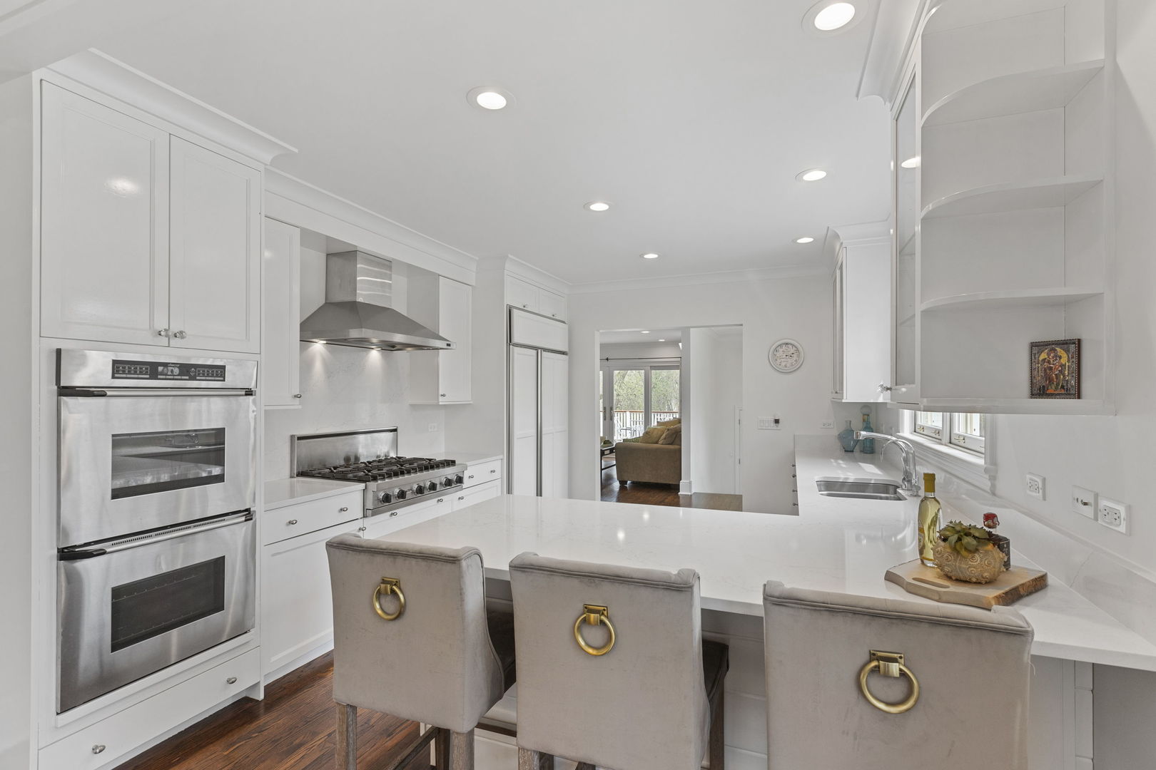 91 Wagner Road Northfield, IL 60093 - Photo 9 of 32 a kitchen with kitchen island a stove a sink and a refrigerator with wooden floor