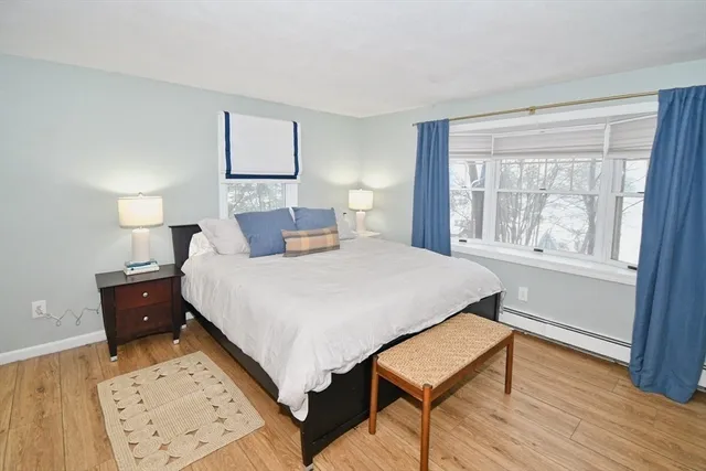 a spacious bedroom with a bed and a fireplace