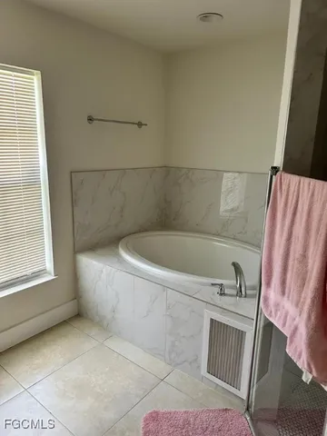 a bath tub sitting in a bathroom next to a window