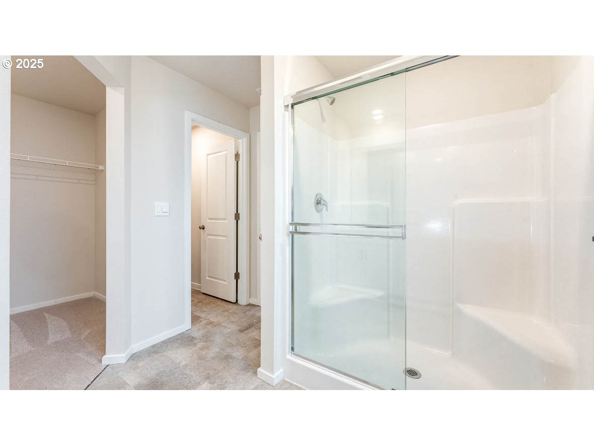2869 U Street Springfield, OR 97477 - Photo 25 of 27 a bathroom with a glass shower door