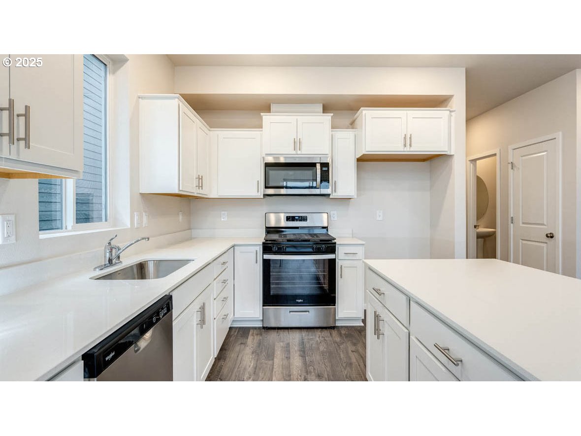 2869 U Street Springfield, OR 97477 - Photo 8 of 27 a kitchen with a sink stove and microwave