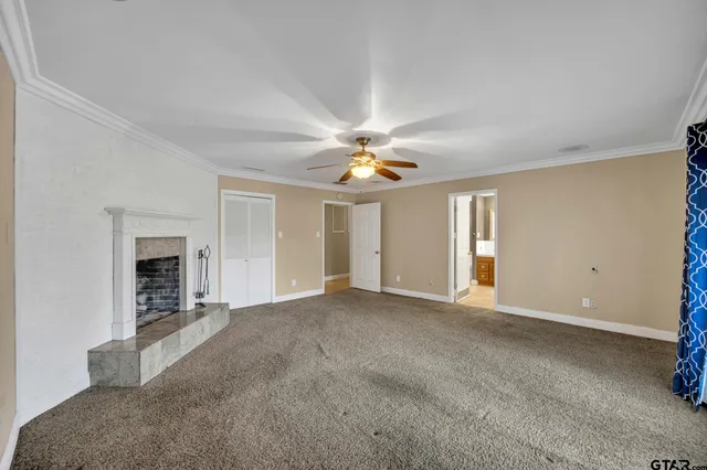 a view of an empty room with a fireplace