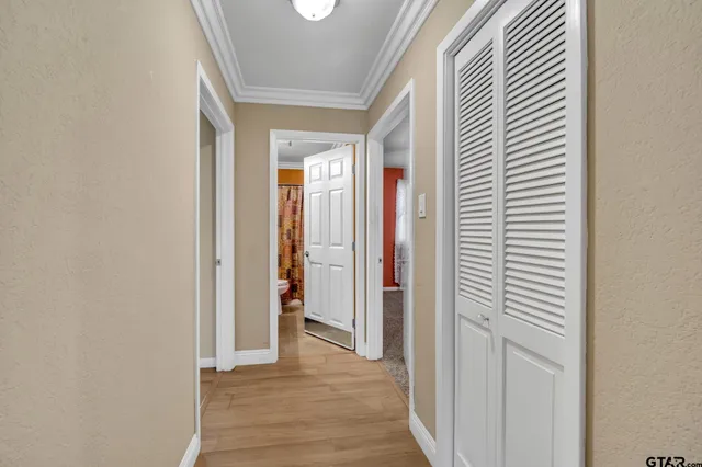 a view of a hallway with wooden floor