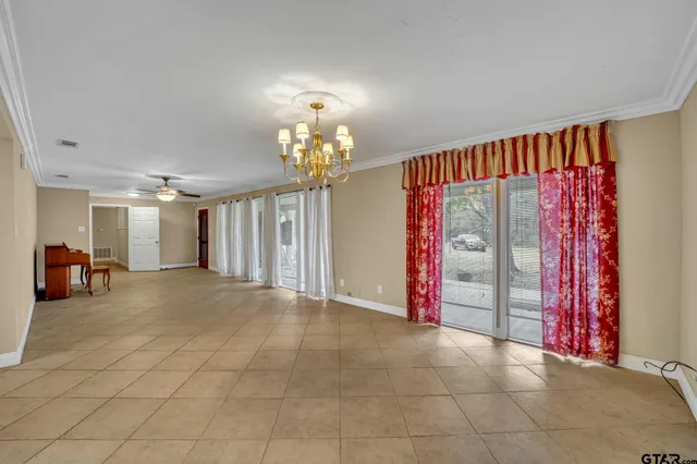 a view of a livingroom with a chandelier furniture and entryway