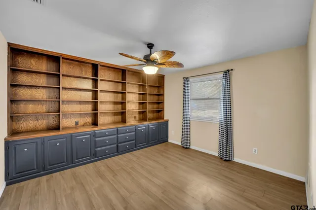 a bathroom with a granite countertop double vanity sink and a mirror