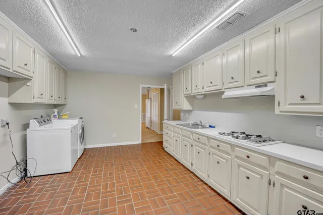 a view of a kitchen with washer and dryer