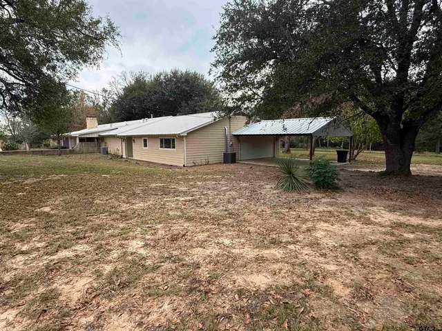 a view of a backyard with large trees