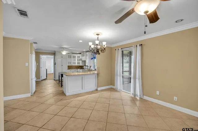 a kitchen with kitchen island cabinets and refrigerator