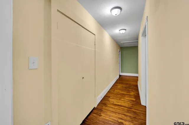 a view of a hallway with wooden floor