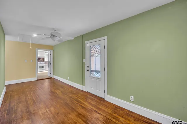 an empty room with wooden floor and closet