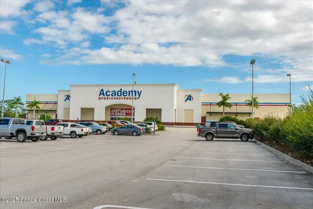 a front view of a house with a garden and trees