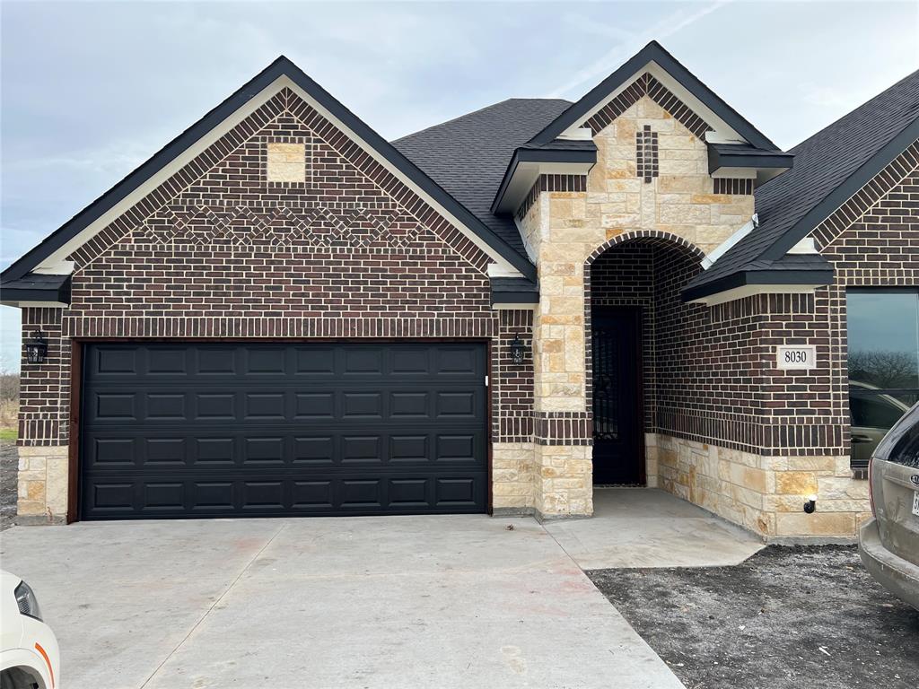 a front view of a house with a garage