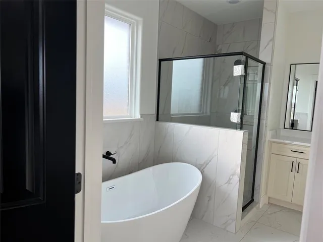 a bathroom with a bathtub and a shower