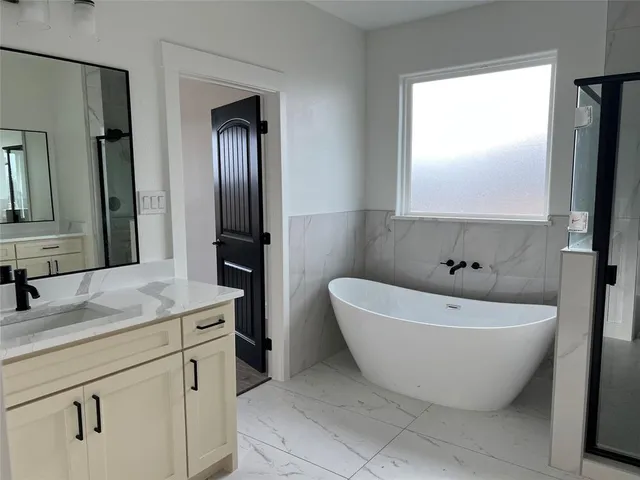 a bathroom with a bathtub and a sink