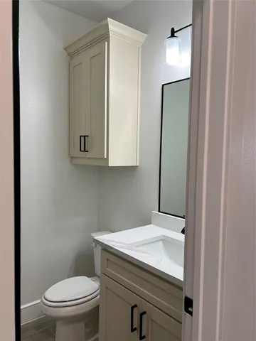 a bathroom with a sink a toilet and mirror