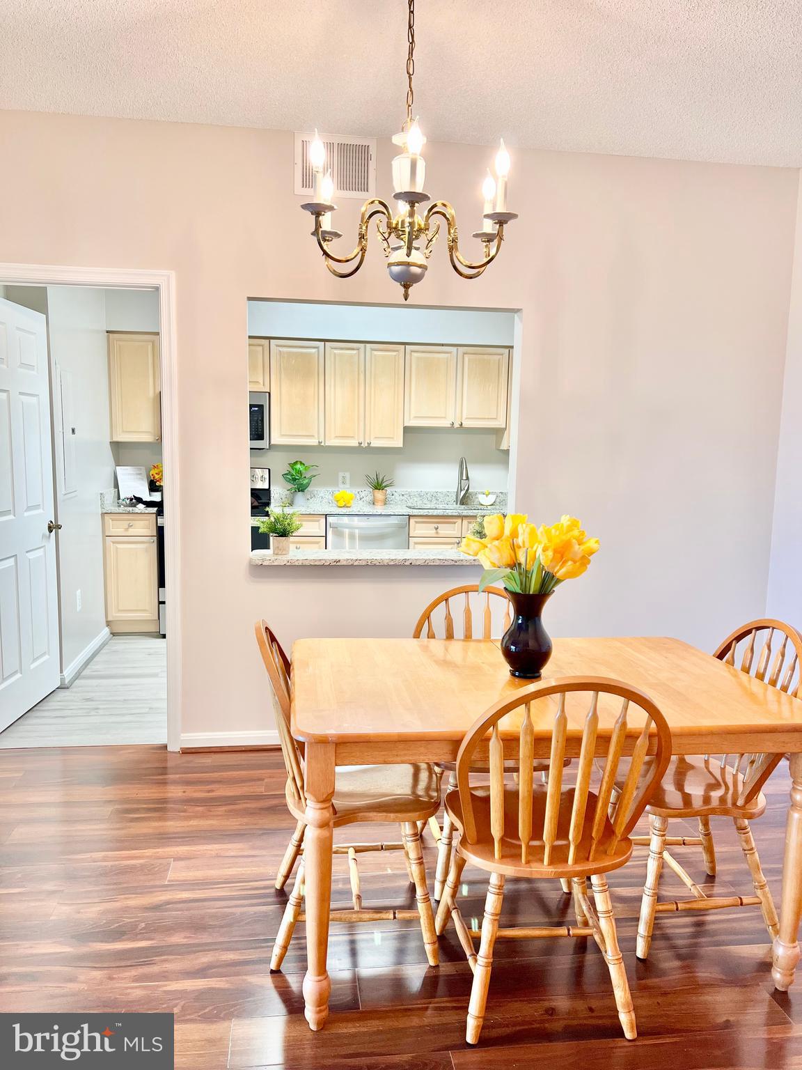 3200 North Leisure World Boulevard, Unit 314 Silver Spring, MD 20906 - Photo 16 of 42 a view of a dining room with furniture and wooden floor