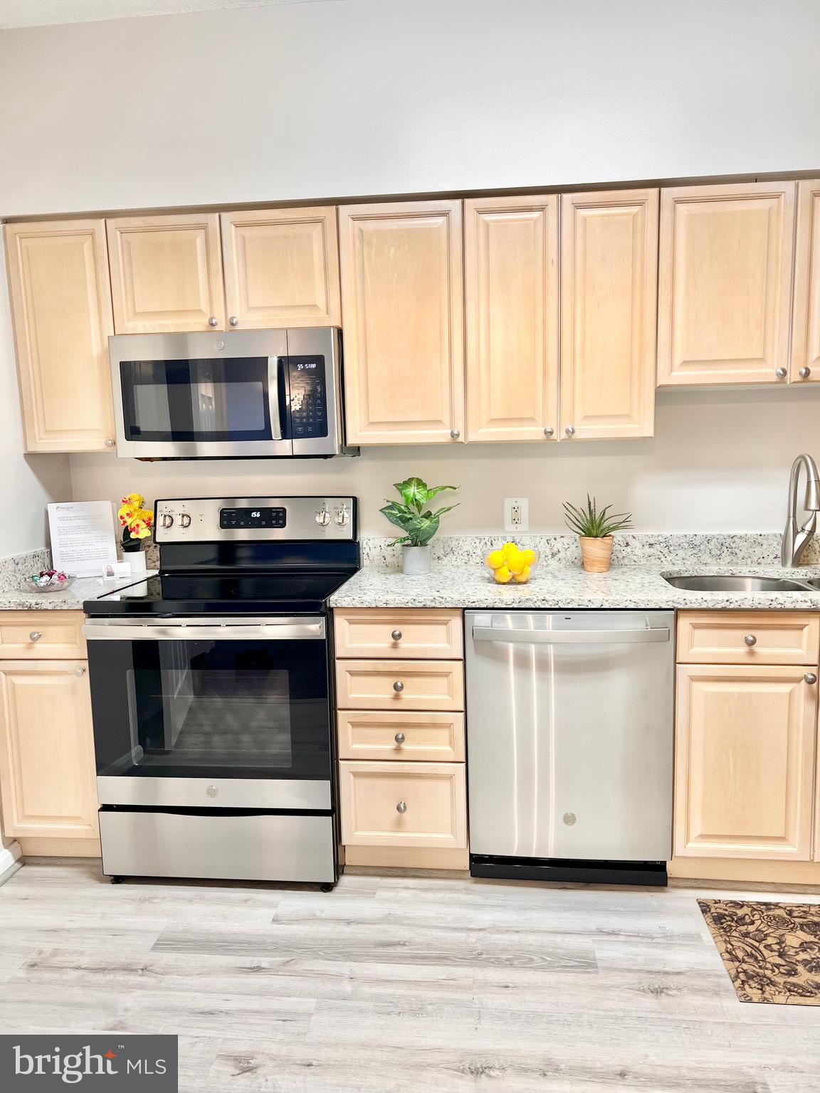 3200 North Leisure World Boulevard, Unit 314 Silver Spring, MD 20906 - Photo 20 of 42 a kitchen with a stove white cabinets and a window