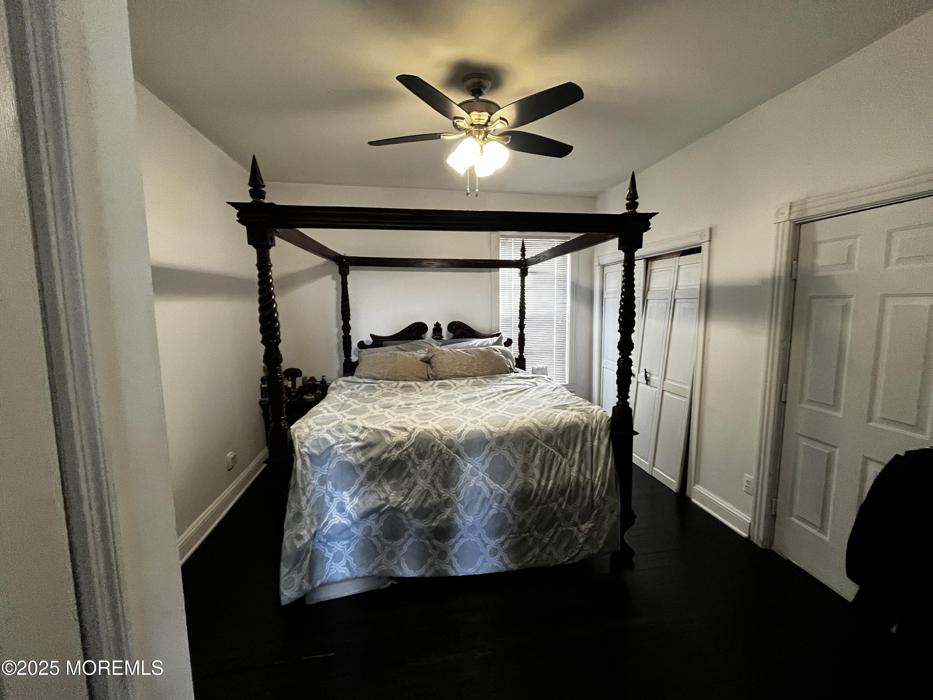 15 Rector Place, Unit A Red Bank, NJ 07701 - Photo 3 of 4 a bed room with a bed and a ceiling fan